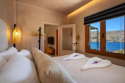 a bedroom with a bed with two towels on it at Gama luxury living in Symi
