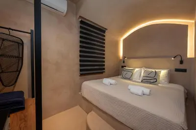a bedroom with a bed with two towels on it at Gama luxury living in Symi