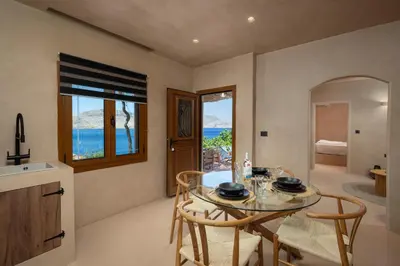 a kitchen and dining room with a table and chairs at Gama luxury living in Symi