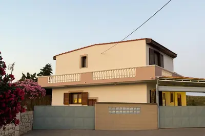 a house with a fence in front of it at Casa Maria Tsampika-Spacious Home with 2 Bathrooms & Free Parking in Psinthos