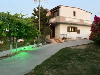 a house with a driveway in front of it at Casa Maria Tsampika-Spacious Home with 2 Bathrooms & Free Parking in Psinthos