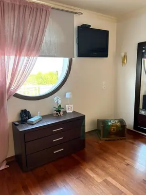 a living room with a dresser and a large window at Casa Maria Tsampika-Spacious Home with 2 Bathrooms & Free Parking in Psinthos