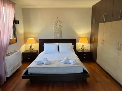 a bedroom with a bed with two towels on it at Casa Maria Tsampika-Spacious Home with 2 Bathrooms & Free Parking in Psinthos