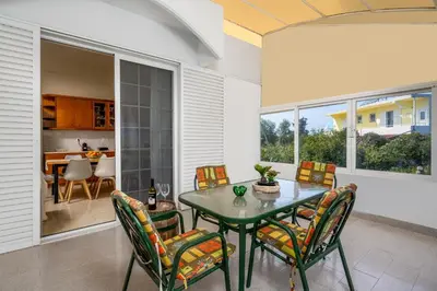 a dining room with a table and chairs at Flora Beach House in Kremasti