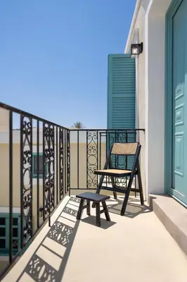 a bench on the balcony of a house at Via Vasileia in Kattavía