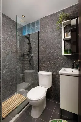 a bathroom with a toilet and a shower at Hill & Sea View White Pearl Villa in Afantou
