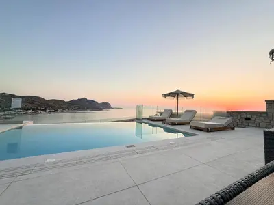 a swimming pool with a view of the ocean at Blue Infinito Boutique Villa, Infinity Pool , Heated Jacuzzi & Panoramic Sea View in Archangelos