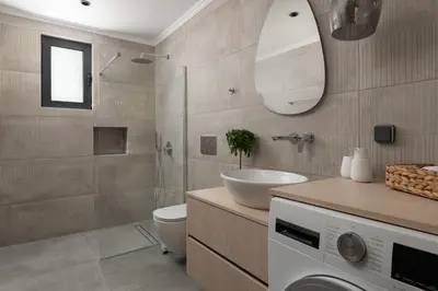 a bathroom with a toilet and a sink and a shower at Blue Infinito Boutique Villa, Infinity Pool , Heated Jacuzzi & Panoramic Sea View in Archangelos