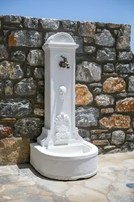 a white statue in front of a stone wall at Villa Clara in Gennadi