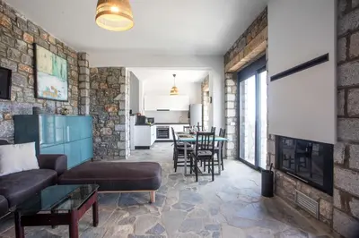 a living room with a couch and a fireplace at Villa Clara in Gennadi