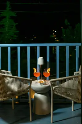 two chairs and a table with two glasses on a balcony at Anteli Luxury Villa in Halki