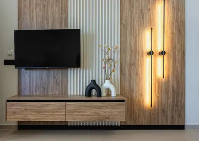 a living room with a television on a wooden cabinet at Aigialí Essence in Vrachonisída touArchangélou