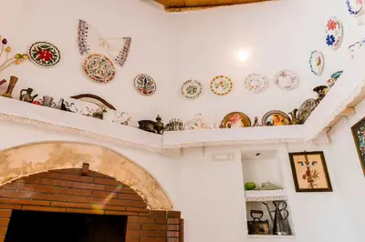 a living room with plates and dishes on a wall at Kamariko Traditional House in Afantou