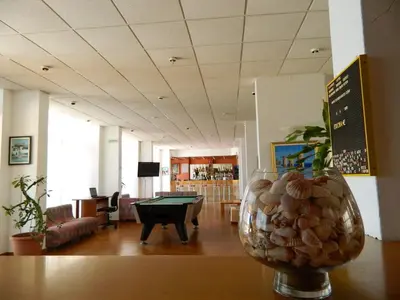 a room with a pool table and a vase filled with nuts at Telhinis Hotel & Apartments in Faliraki