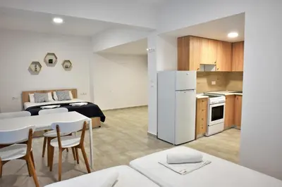 a small apartment with a kitchen and a bedroom at Telhinis Hotel & Apartments in Faliraki