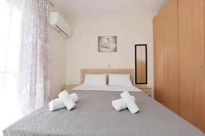 a bedroom with a bed with two white pillows at Seraina House in Pastida