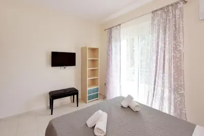 a bedroom with a bed and a window with towels at Seraina House in Pastida