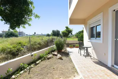 a patio with a table and chairs next to a building at Seraina House in Pastida