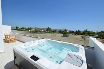 a hot tub on a balcony with a view at Kathara bay Studios in Faliraki