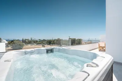 a hot tub on the roof of a house at Kathara bay Studios in Faliraki