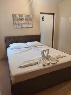 a bed with towels on top of it with a mirror at Liora in Rhodes Town