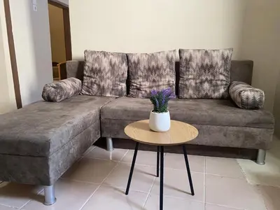 a living room with a couch and a table at Liora in Rhodes Town