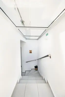 a hallway in an empty room with a skylight at Panormitis House Semi-basement apartment in Pastida
