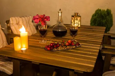 a table with two candles and two glasses of wine at Finestra Medieval Home in Rhodes Town