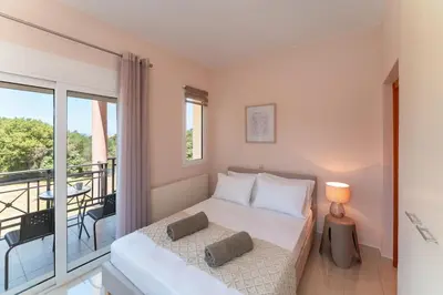 a bedroom with a bed and a balcony at SunnyVilla Rhodes in Ialyssos