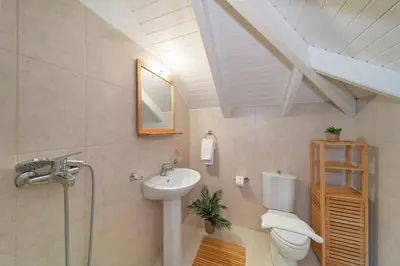 a bathroom with a toilet and a sink at SunnyVilla Rhodes in Ialyssos