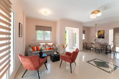 a living room with a couch and chairs and a table at SunnyVilla Rhodes in Ialyssos