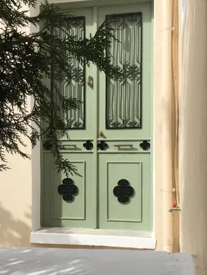 a green front door of a house at Doukissa's House I -Symi - House with sea view in Symi