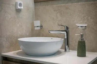 a bathroom with a white sink and a faucet at Vasi Luxury Apartment in Rhodes Town