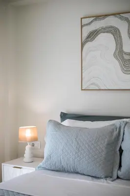 a bedroom with a bed with a picture on the wall at Vasi Luxury Apartment in Rhodes Town