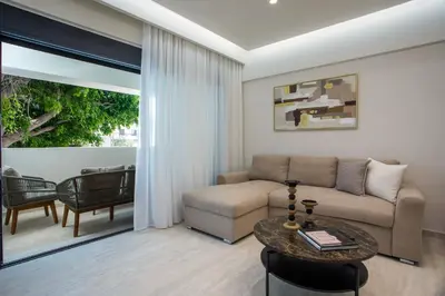 a living room with a couch and a table at Vasi Luxury Apartment in Rhodes Town
