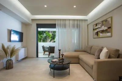 a living room with a couch and a table at Vasi Luxury Apartment in Rhodes Town
