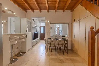 a kitchen and dining room with a table and chairs at The Neo-Classic Loft in Rhodes Town