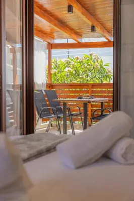 a room with chairs and a table and a window at The Neo-Classic Loft in Rhodes Town