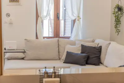 a white couch with pillows in a living room at The Neo-Classic Loft in Rhodes Town