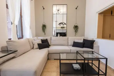 a living room with a couch and a table at The Neo-Classic Loft in Rhodes Town