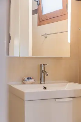 a bathroom sink with a mirror and a sink at The Neo-Classic Loft in Rhodes Town