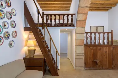 a staircase in a house with a couch and a lamp at White House 1871 in Lachania