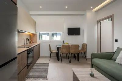 a kitchen and living room with a couch and a table at Dia Luxury Apartments in Rhodes Town