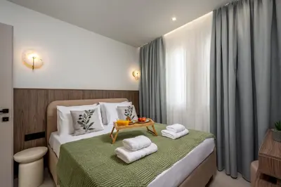 a hotel room with a bed with towels on it at Dia Luxury Apartments in Rhodes Town