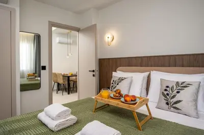 a bedroom with a bed with a tray of fruit on it at Dia Luxury Apartments in Rhodes Town