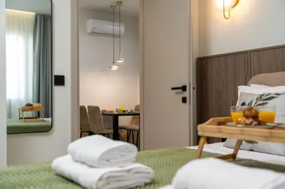 a hotel room with a bed and a table with towels at Dia Luxury Apartments in Rhodes Town