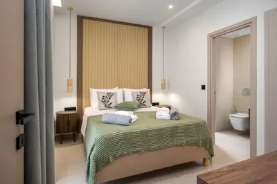 a bedroom with a bed with towels on it at Dia Luxury Apartments in Rhodes Town