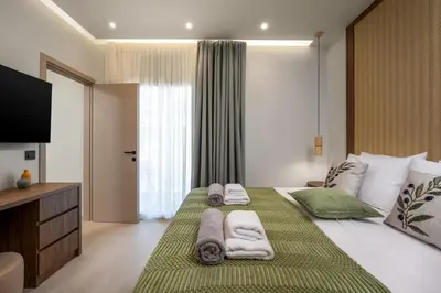 a bedroom with a large bed with towels on it at Dia Luxury Apartments in Rhodes Town