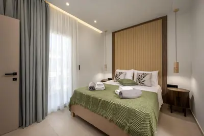 a bedroom with a bed with towels on it at Dia Luxury Apartments in Rhodes Town