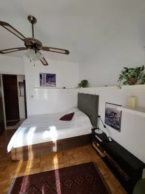 a bedroom with a bed and a ceiling fan at Antony's Elli beach home in Rhodes Town